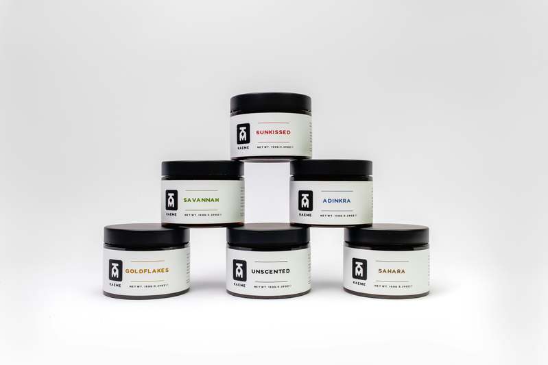 Collection of elegant scented lotion bottles arranged on marble surface with dried lavender and rose petals